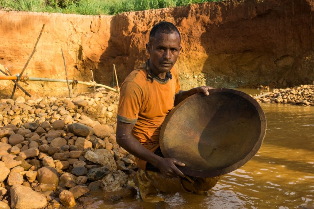 Mineiro trabalhando na extração de pedras de onde será extraído o ouro. Foto: Bram Ebus/InfoAmazonia.